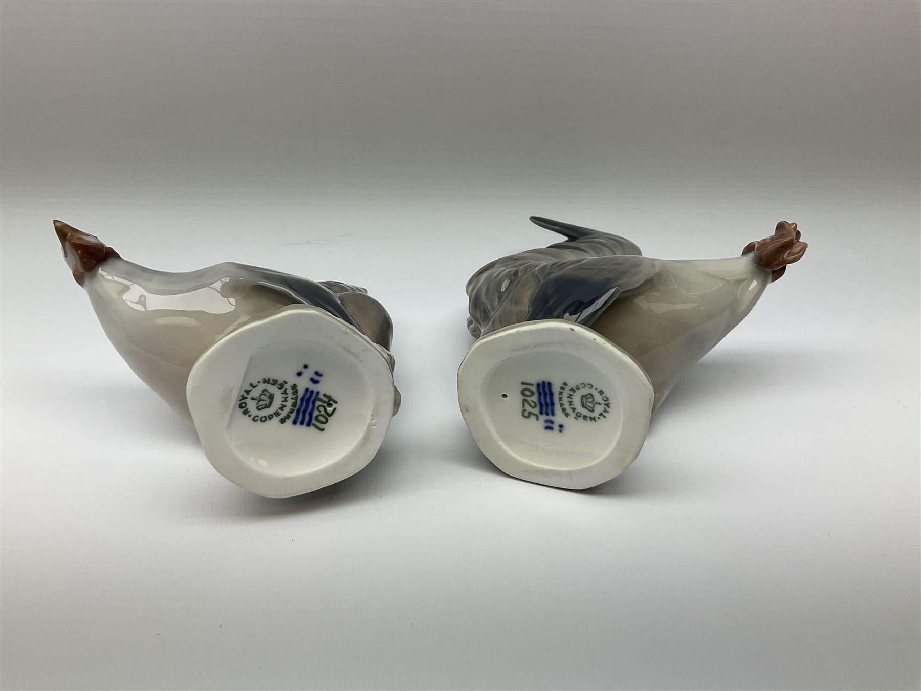 Eight Royal Copenhagen figures, cockerel 1025, hen 1024, group of two geese 609, robin 2266, squirrel 982, cockerel 1127, goose 1088 and owl 1741.  