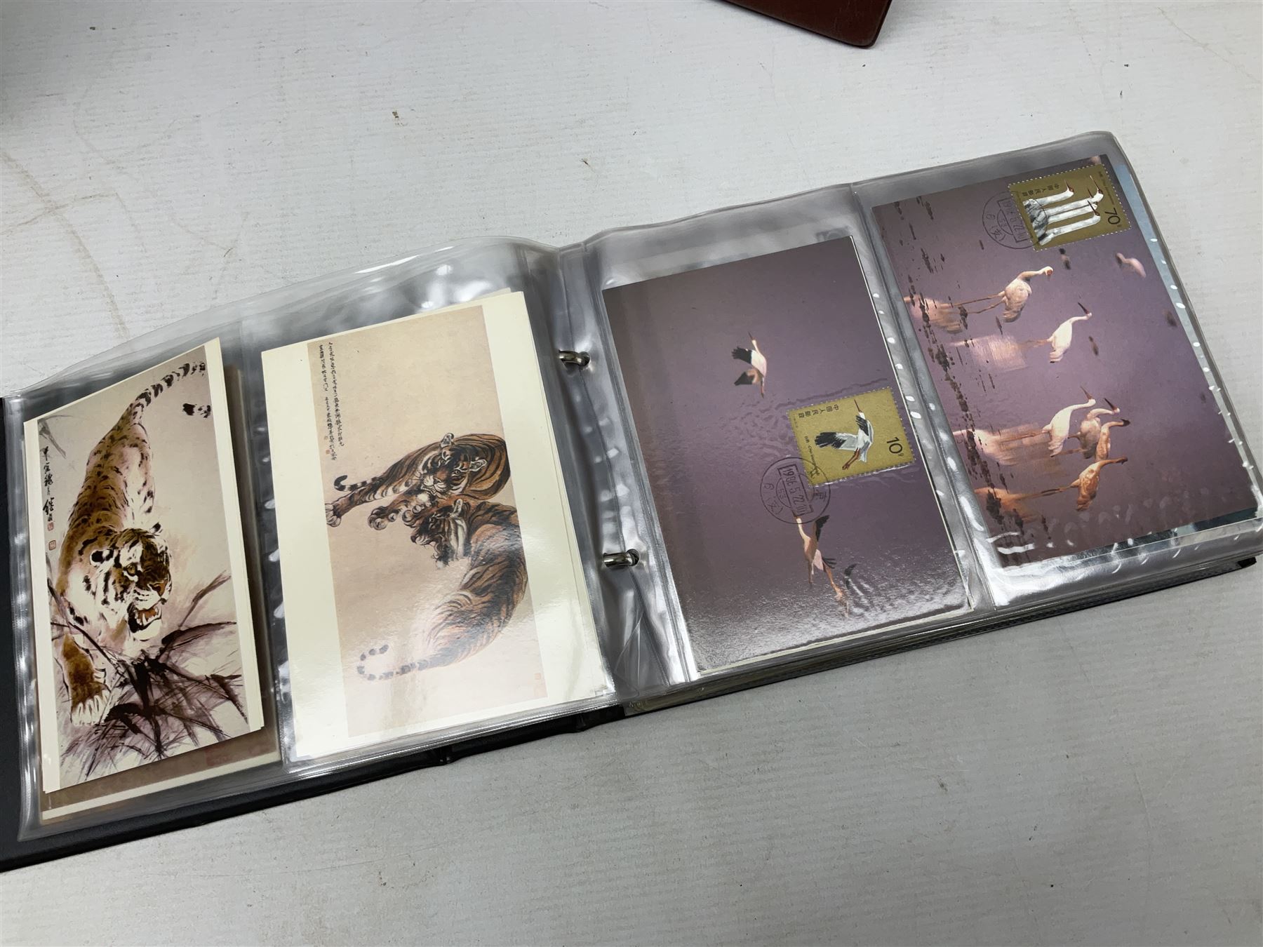 Mostly Chinese stamps including  covers and postcards, many being from the 80s and 90s, housed in ten folders