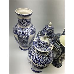 A large collection of modern transfer printed Delft ware, to include large baluster vase, H42cm, two jars and covers, largest H40cm, pair of tapering cylindrical vases, H31cm, and a number of plates of various size and design. 