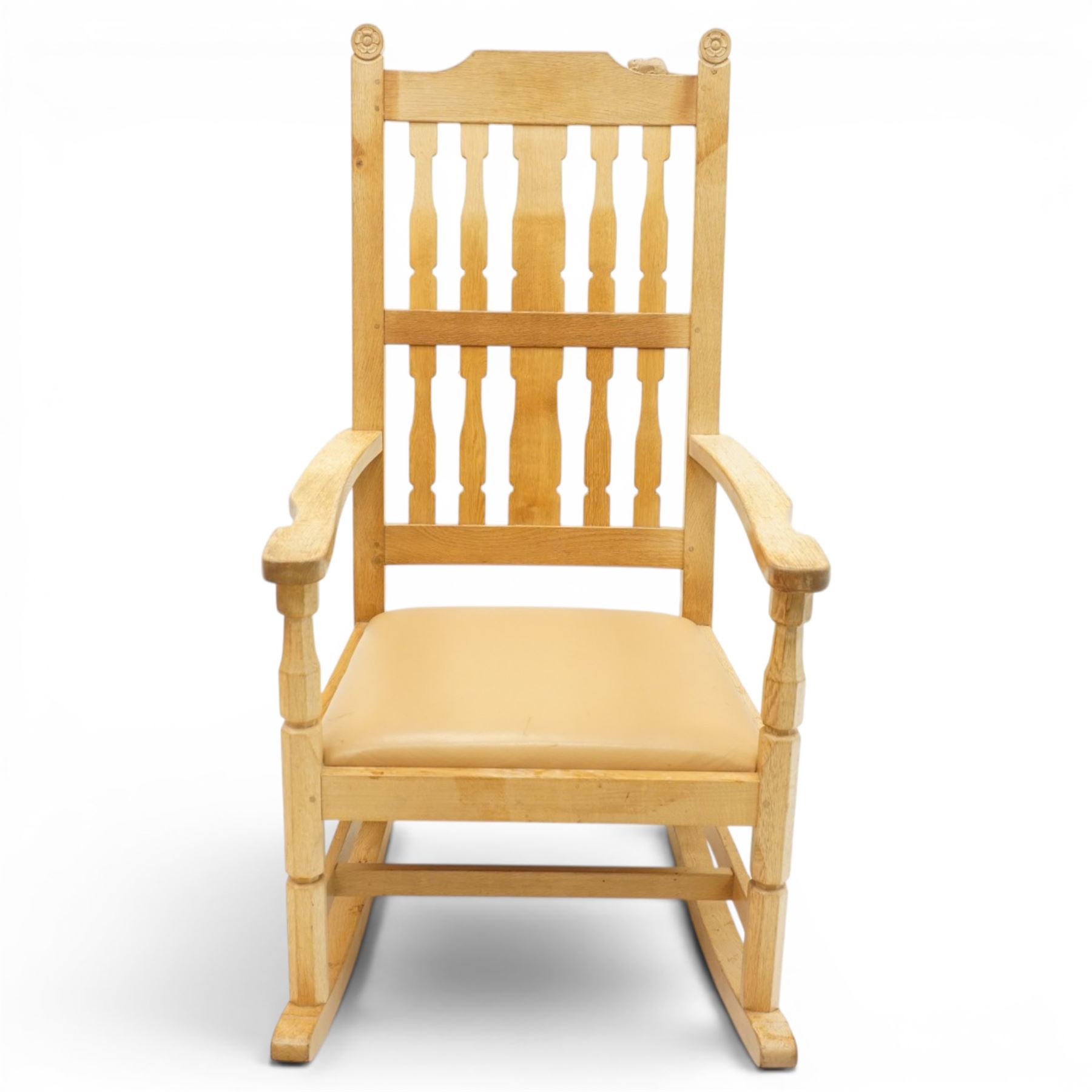 Beaverman - oak 'Ripley' rocking chair with shaped lathe backs and leather seat, with signature Beaver carving to the top rail, flanked by Yorkshire Roses, by Colin Almack of Sutton near Thirsk