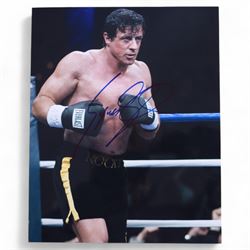 Four Sylvester Stallone film stills and promotional shots, including one depicting Rocky Balboa in the ring, three signed by Sylvester Stallone and one signed by Brigette Nielsen, all with certificates of authenticity