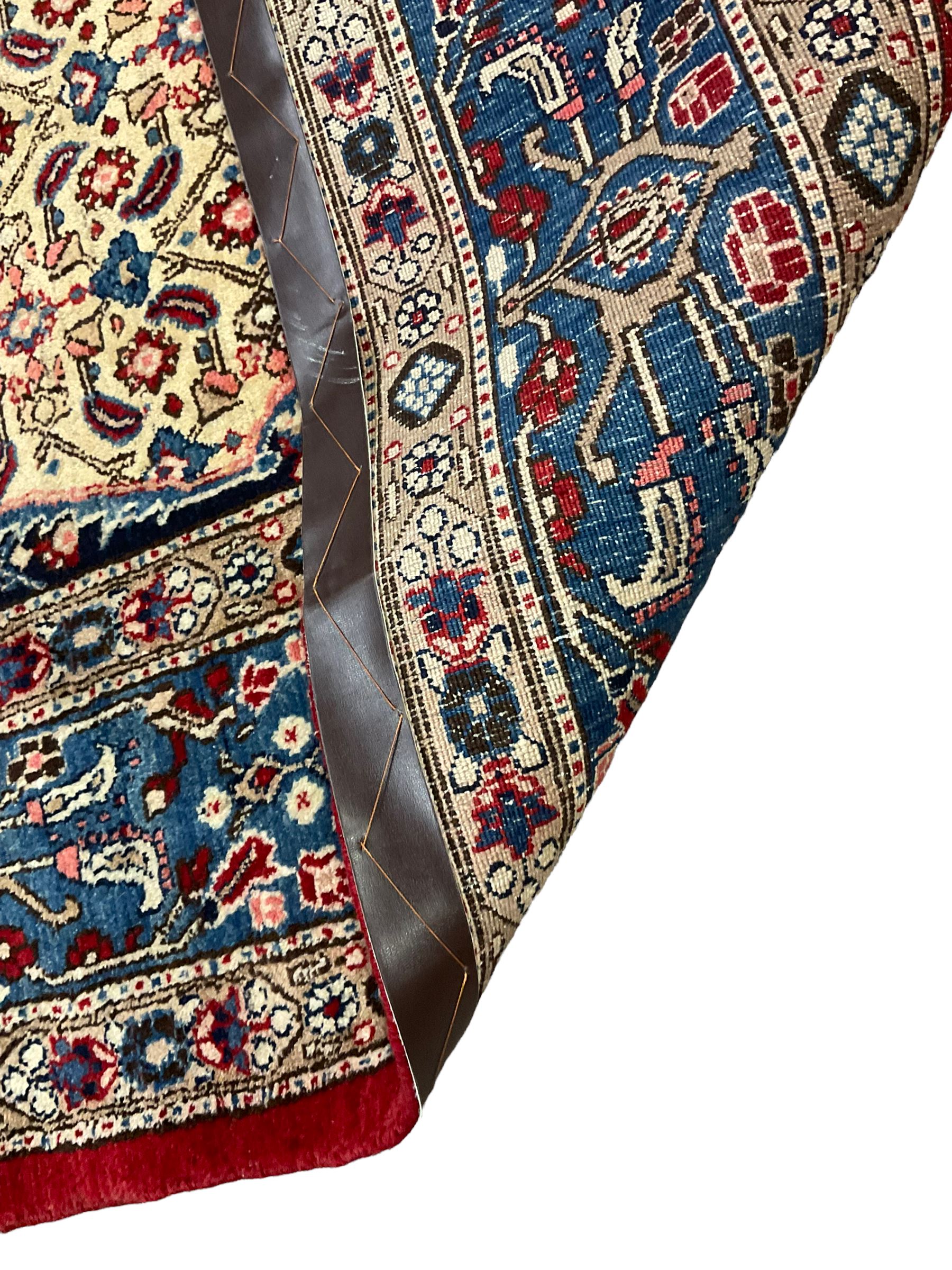 Persian Moud carpet, the field decorated all-over with Herati motifs, central medallion and spandrels decorated with stylised plant and flower head motifs, repeating border with guard