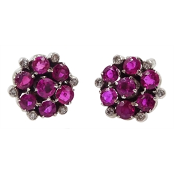 Pair of 9ct white gold ruby and diamond cluster stud earrings, retailed by J W Benson Ltd, London boxed