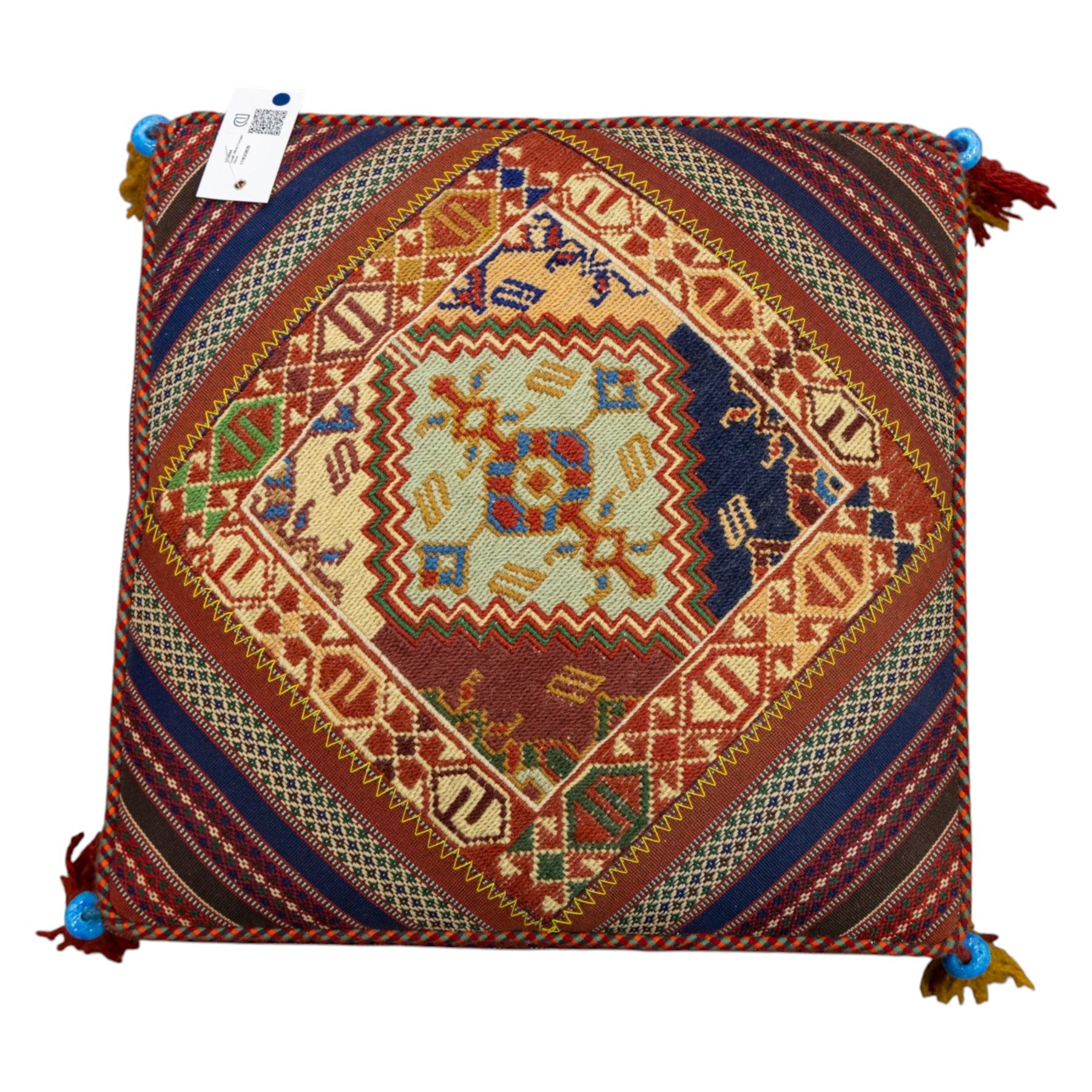 South West Persian Qashqai stool, square flatwoven top with central geometric medallion enclosed within a stepped border the sides decorated with striped bands of geometric motifs with tasselled corners 