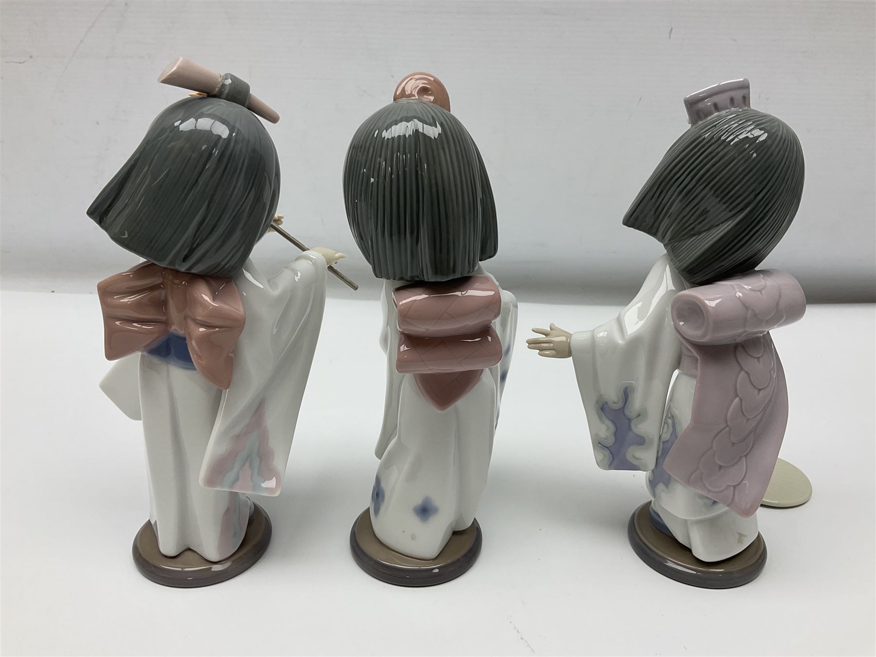 Six Lladro figures of the China doll set and Oriental doll set, comprising Playing the Flute no.6150, Bearing Flowers no.6151, Flower Gazer no. 6152, Oriental Dance no. 6230, Oriental Lantern no. 6231 and Oriental Beauty no. 6232, largest H20cm