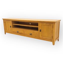 Cotswold & Co - large light oak media stand, rectangular top above central open shelf, double drawer flanked by two panelled cupboard doors, fitted with metal cup and knob handles