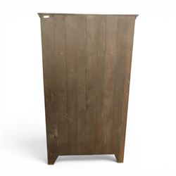 20th century dark stained oak hall robe, cantered sides enclosing a hooks and a shelf, panelled and carved sides, raised on stile supports