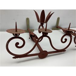 Pair of red painted three branch candle wall sconces, D47cm