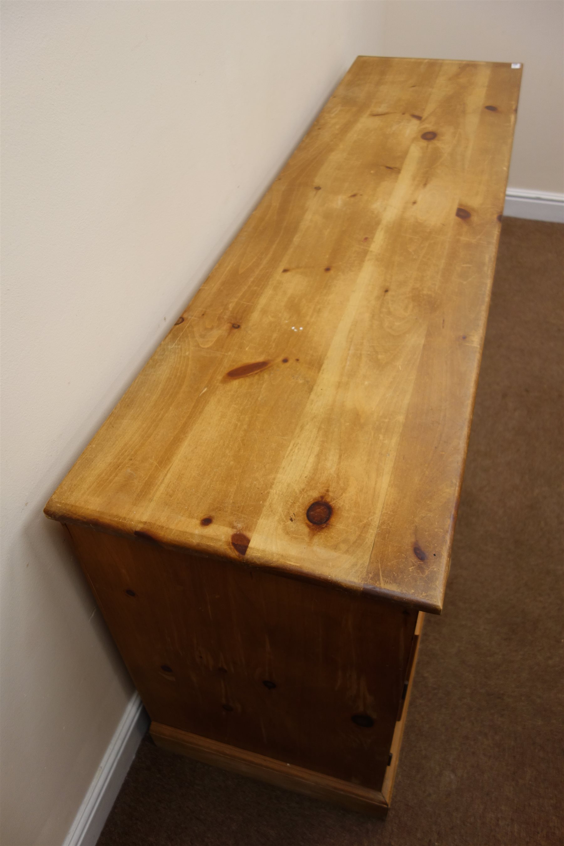 Solid pine dresser base, three drawers above three cupboards, plinth