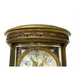French late 19th-century 8-day oval four-glass mantle clock, oval brass case with reeded columns and continuously applied gadroon to the base and cover, cream enamel dial with blue Arabic hours and minutes and floral swag, Louis XIV gilt hands within a cast brass bezel, twin train rack striking Parisian movement striking the hours and half hours on a gong. With pendulum and key.