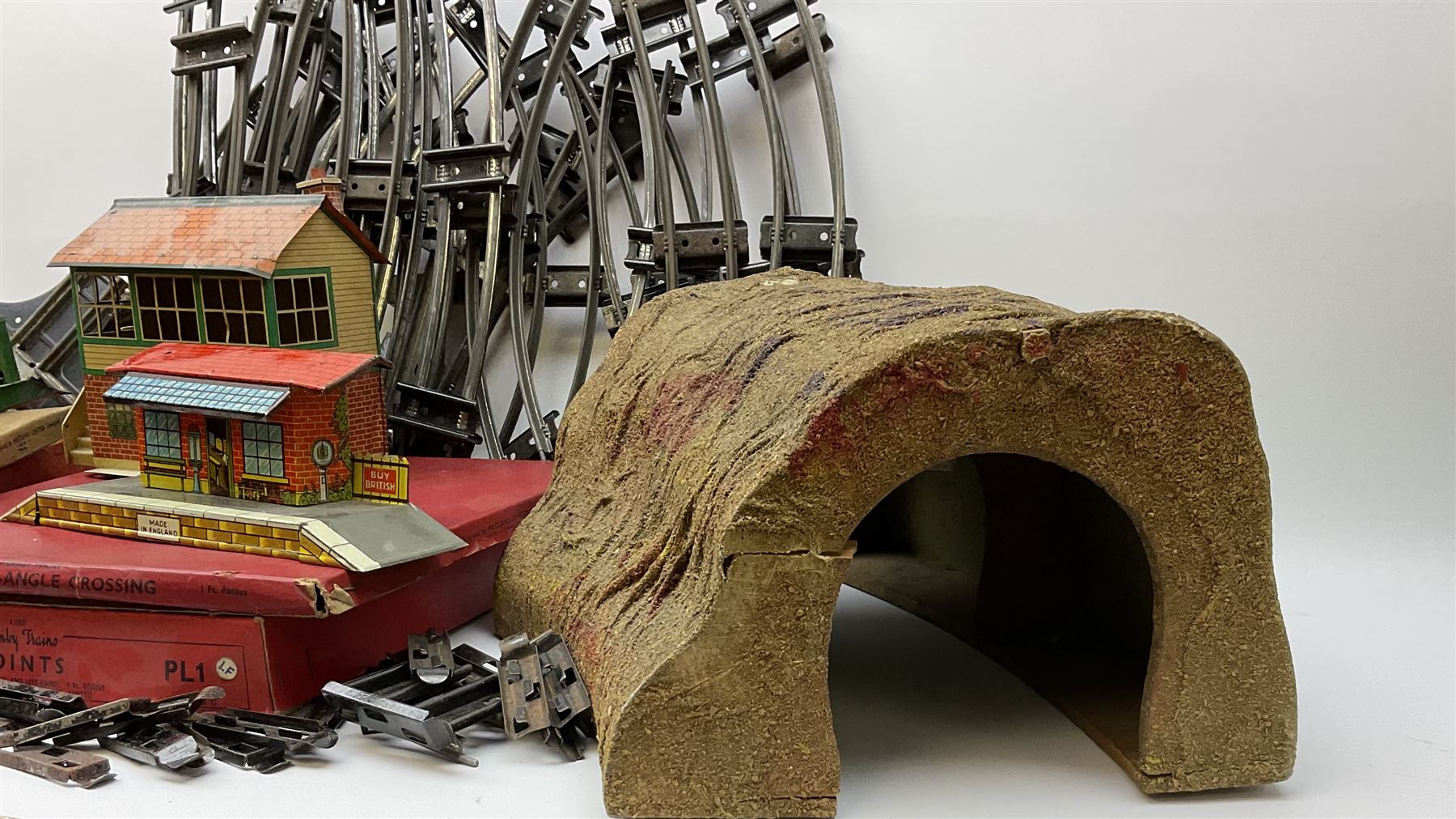 Hornby '0' gauge - layout accessories comprising PR1/PL1 Points, CR1 Right Angle Crossing and CA2 Acute Angle Crossing, all boxed; tin-plate signal box; tin-plate level crossing; textured wooden tunnel, possibly pre-WW2; and quantity of track, some boxed; together with '00' gauge tin-plate station