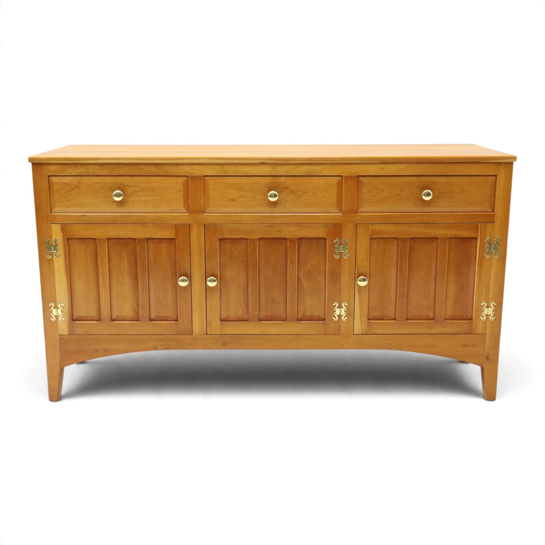 Traditional cherrywood sideboard, rectangular top above three fielded panelled drawers, three cupboard doors with triple panelled doors, brass knobs and hinges, tapered supports