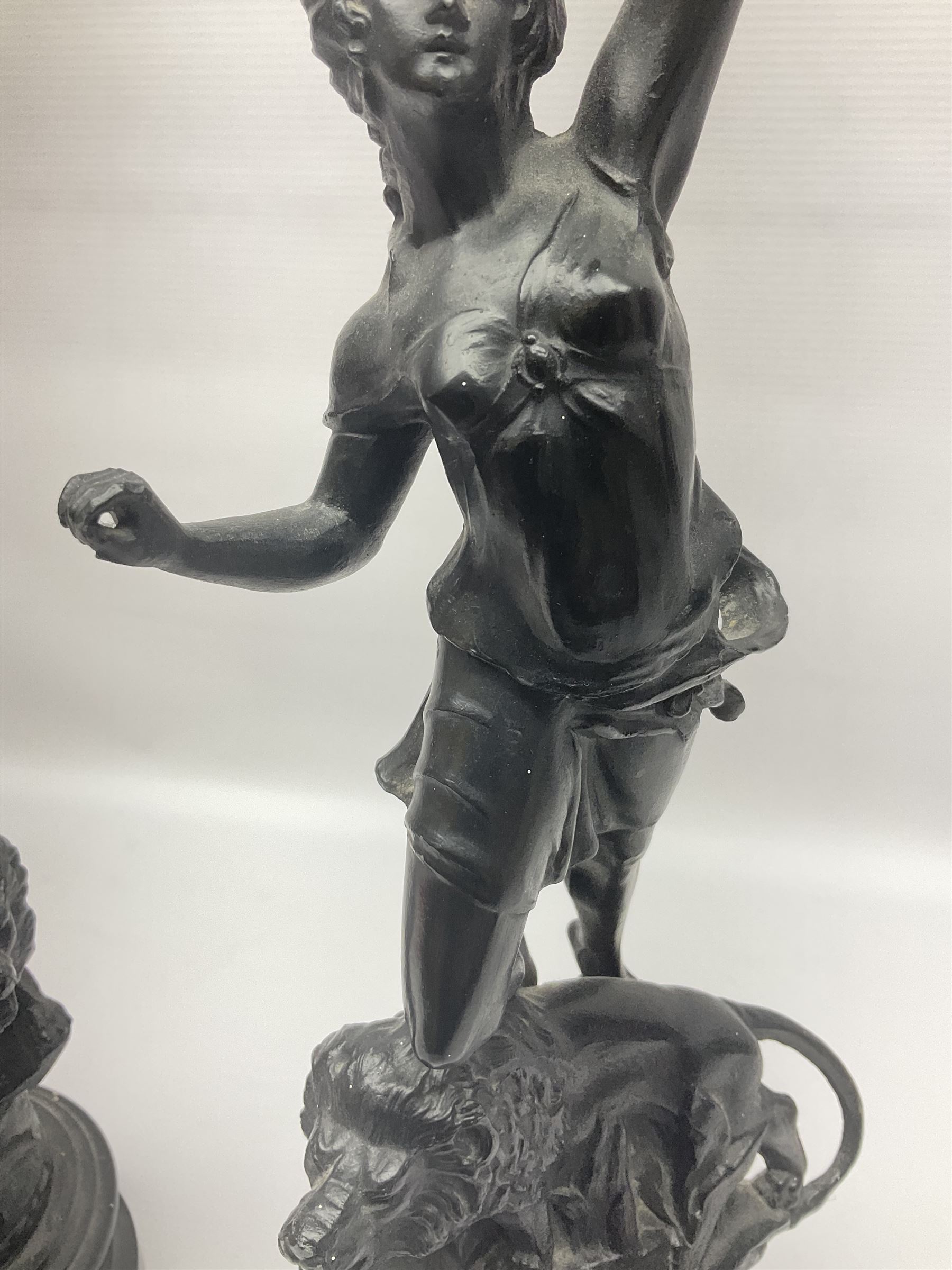 Pair of spelter figures, Le Force and Le Pouvoir, modeled as figures standing on lions, arms held aloft, H51cm 