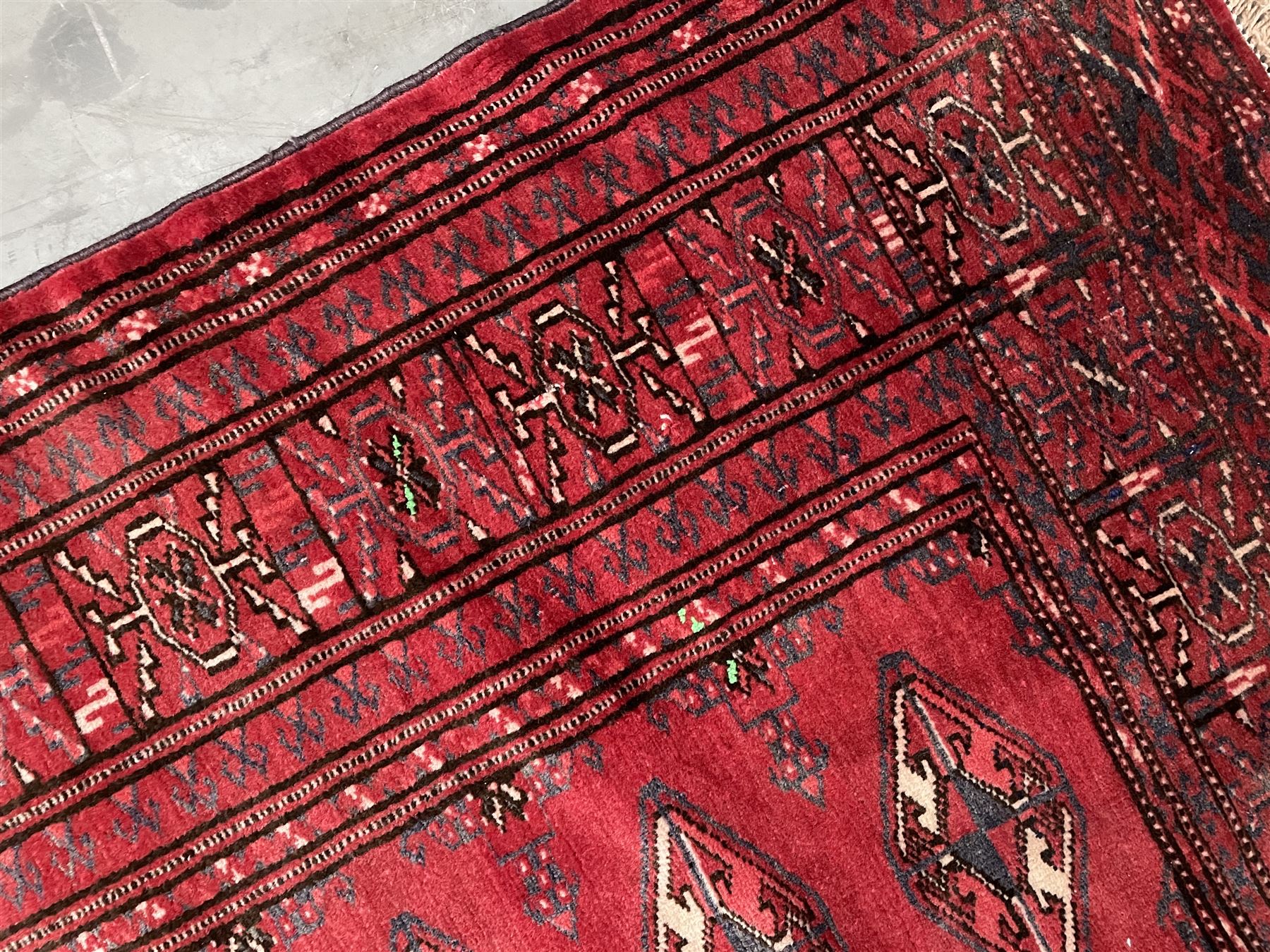 Turkman Bokhara rug, red ground field decorated with repeating Gul motifs