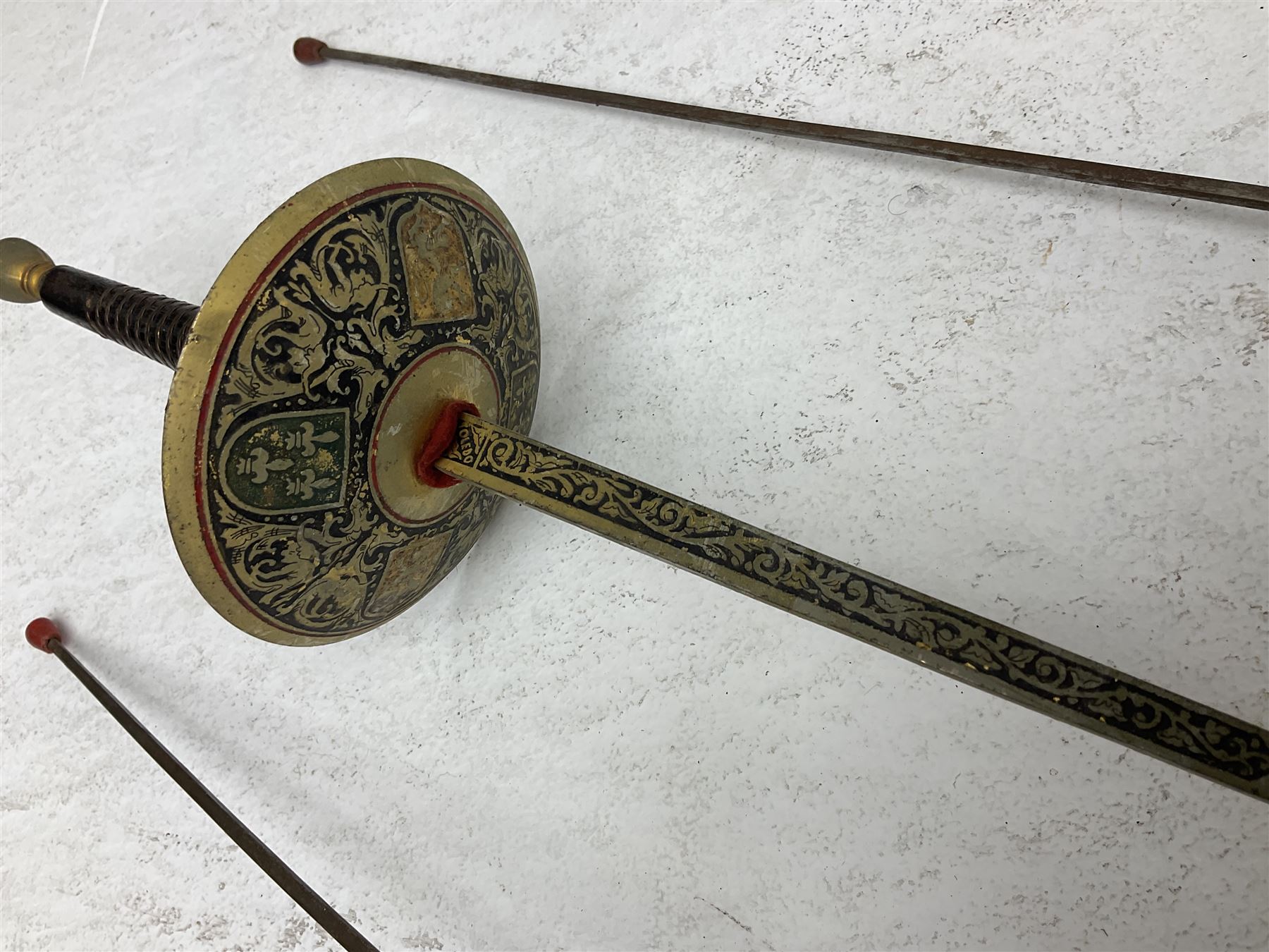 20th century Indian Tulwar sword with 71cm plain curving steel blade and iron hilt with extended langets, knopped grip and spiked pommel; in canvas covered wooden scabbard L87.5cm overall; together with five fencing swords comprising four foils and one epee, three marked Leon Paul, one in carrying case (6)