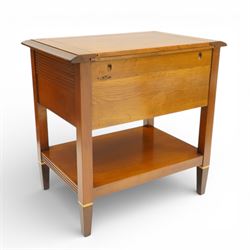 Brigitte Forestier - pair of cherry wood bedside cabinets, moulded rectangular top above two drawers, the top drawer with reeded panels flanking a brass circular pull, the lower drawer with two brass pulls, on square tapering supports united by a full length undertier