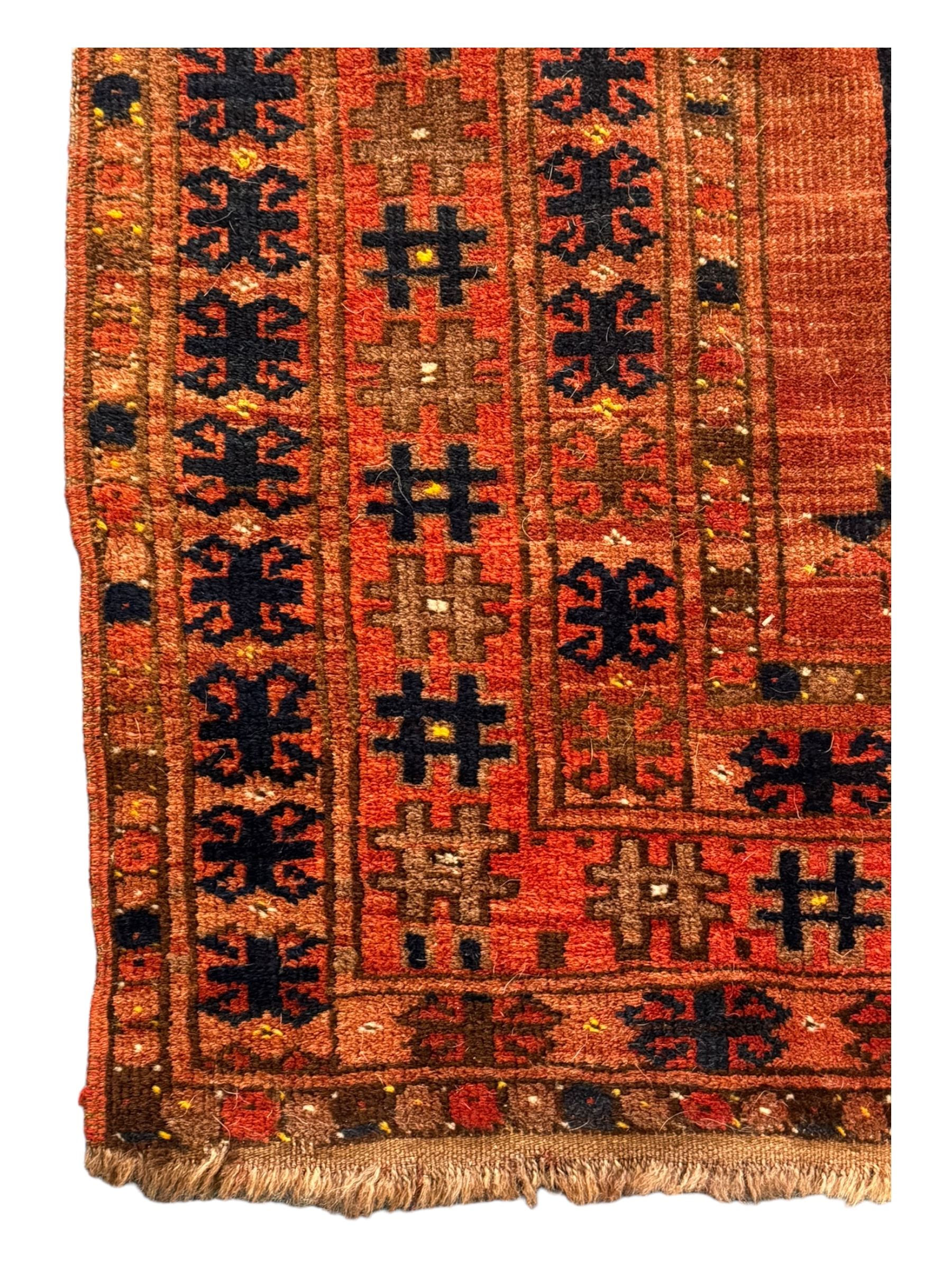 Turkish Kilim ground rug, the field with alternating horizontal bands of geometric patterns, bordered by repeating diamond motifs (145cm x 242cm); Turkish red ground rug, the field with three octagonal medallions (113cm x 172cm) (2)