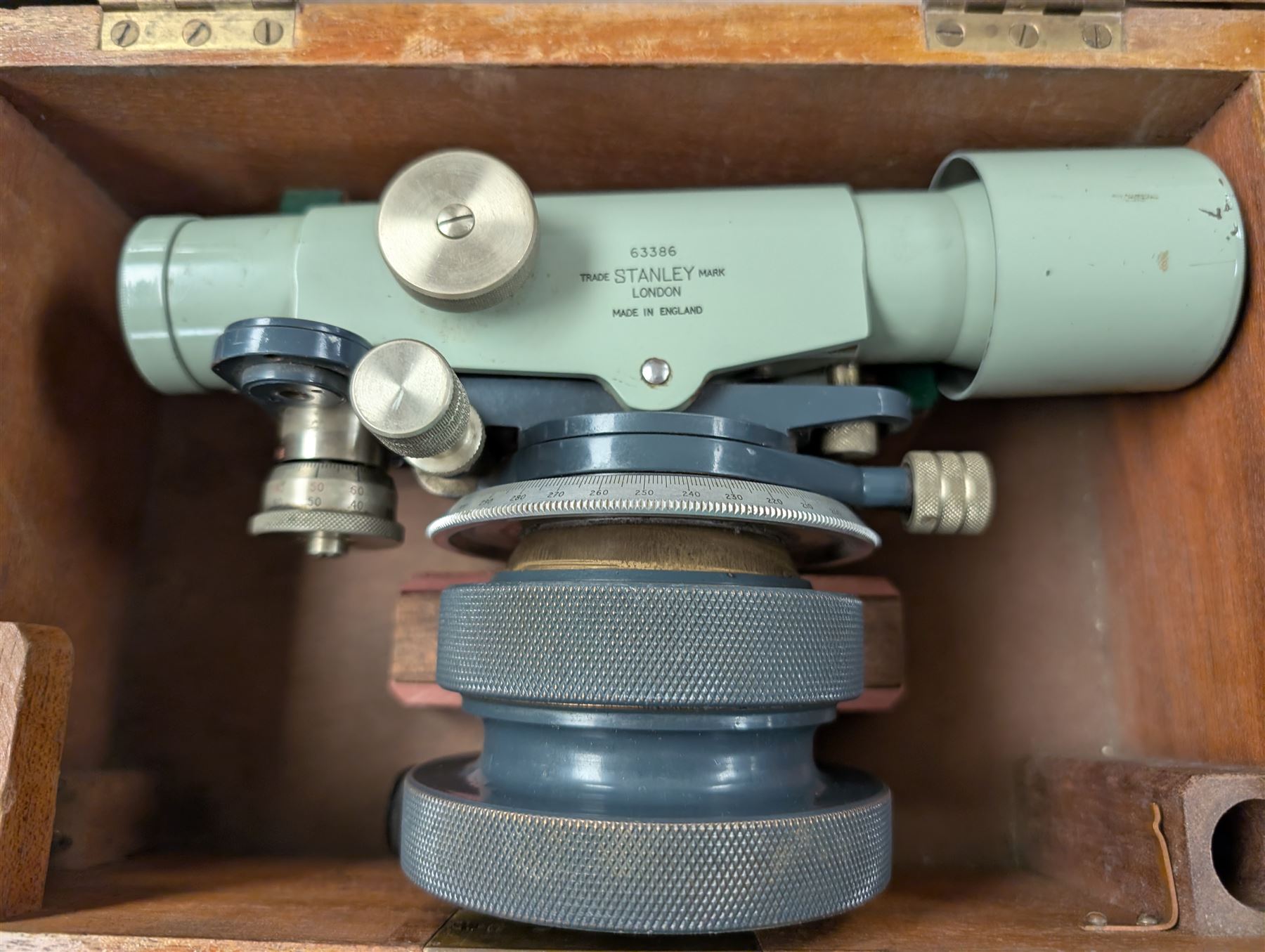 Two theodolites, comprising a Watts example in fitted hard case and a Cooke Troughton and Simms examplie in a wooden case, together with a Stanley dumpy level and a Hall and Watts surveyors measure