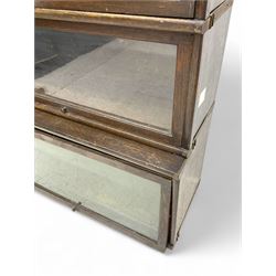 Globe Wernicke - early 20th century oak four-tier stacking library bookcase, four glazed sections enclosed by hinged and sliding doors