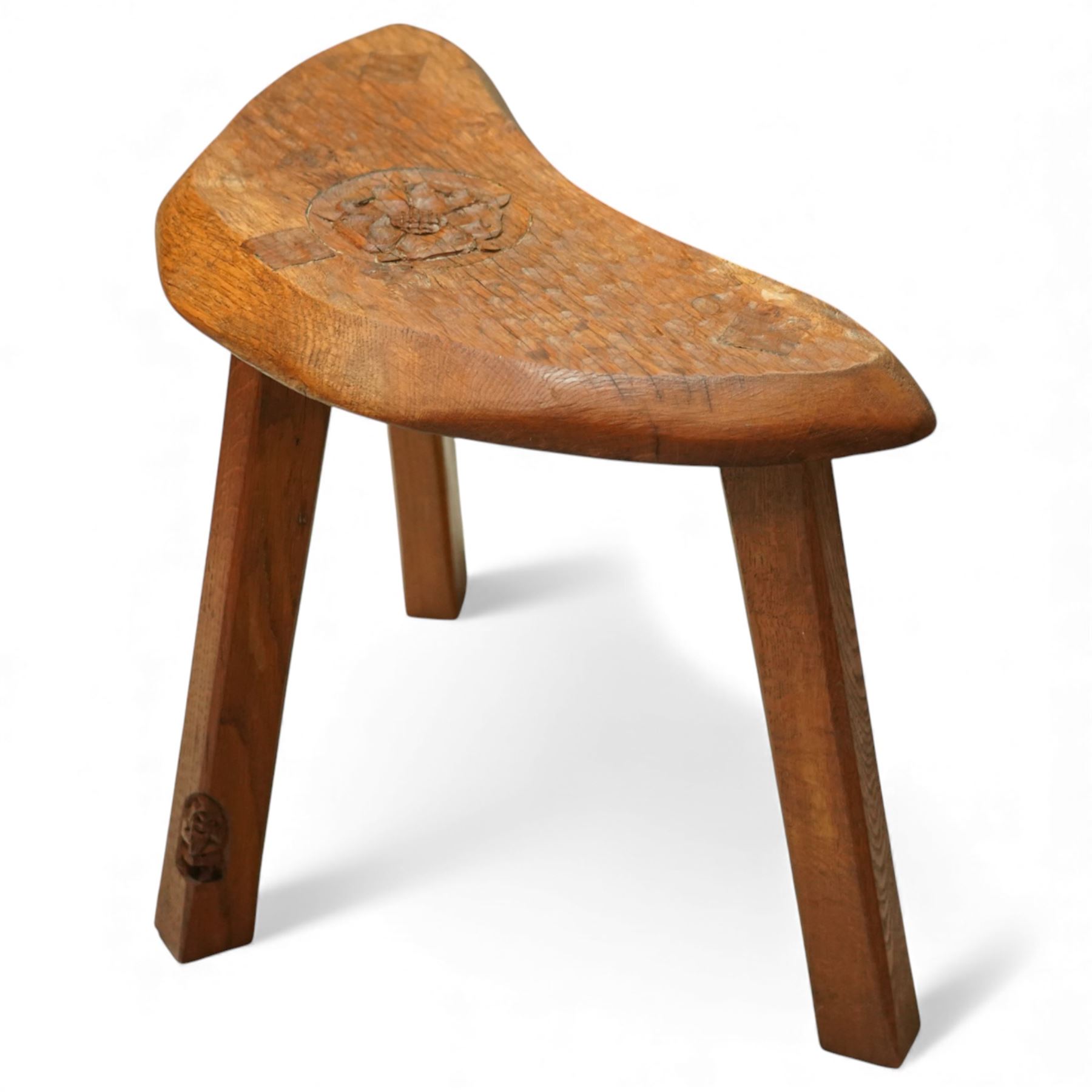 Gnomeman - oak Yorkshire rose milking stool, adzed surface with carving of a Yorkshire rose, exposed wedged through tenons, square legs with chamfered edges, with signature carving of a Gnome, by Thomas Whittaker of Littlebeck
