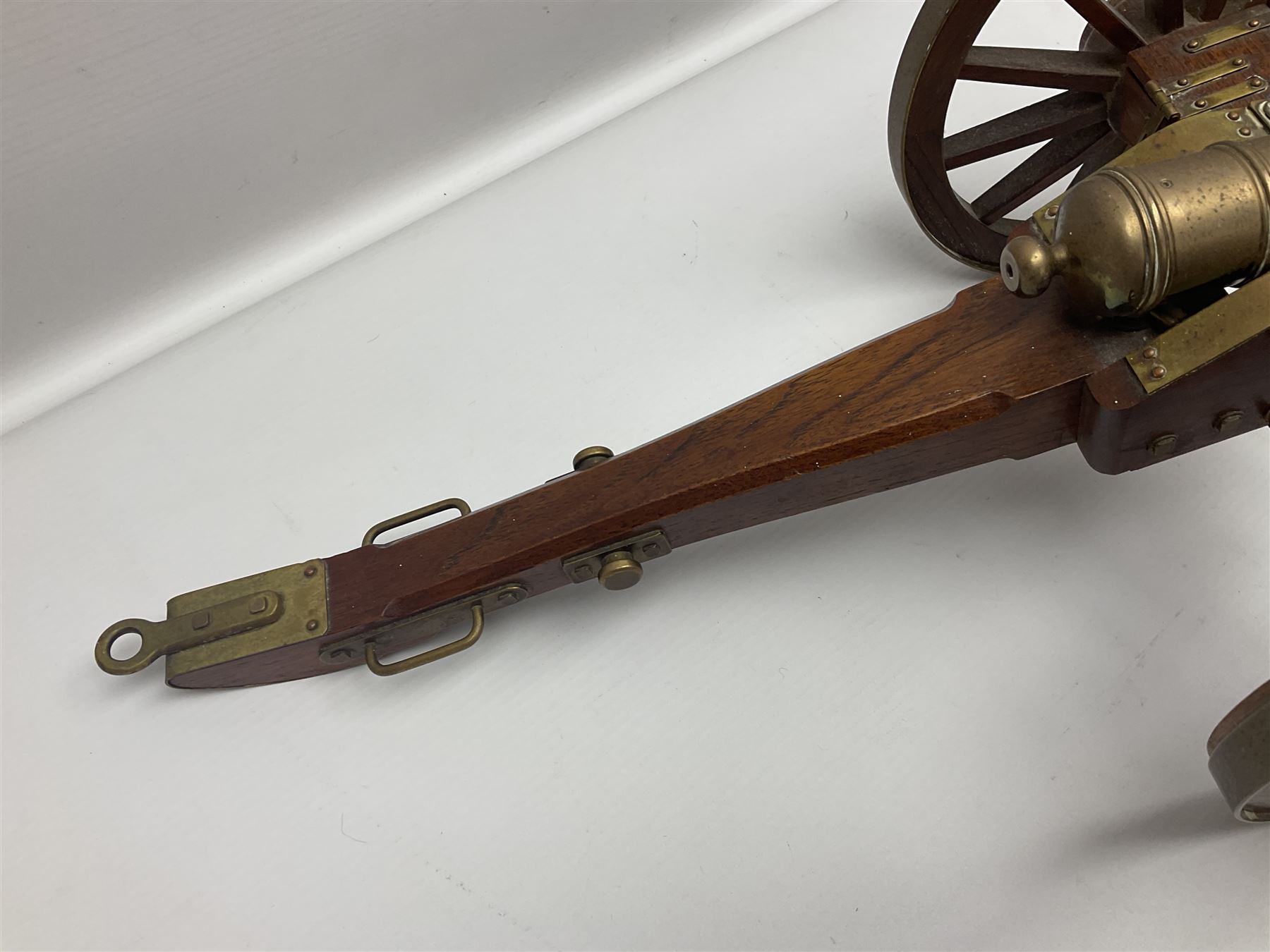 Large model brass cannon, upon wooden base, together with two similar smaller cannons, largest L48cm