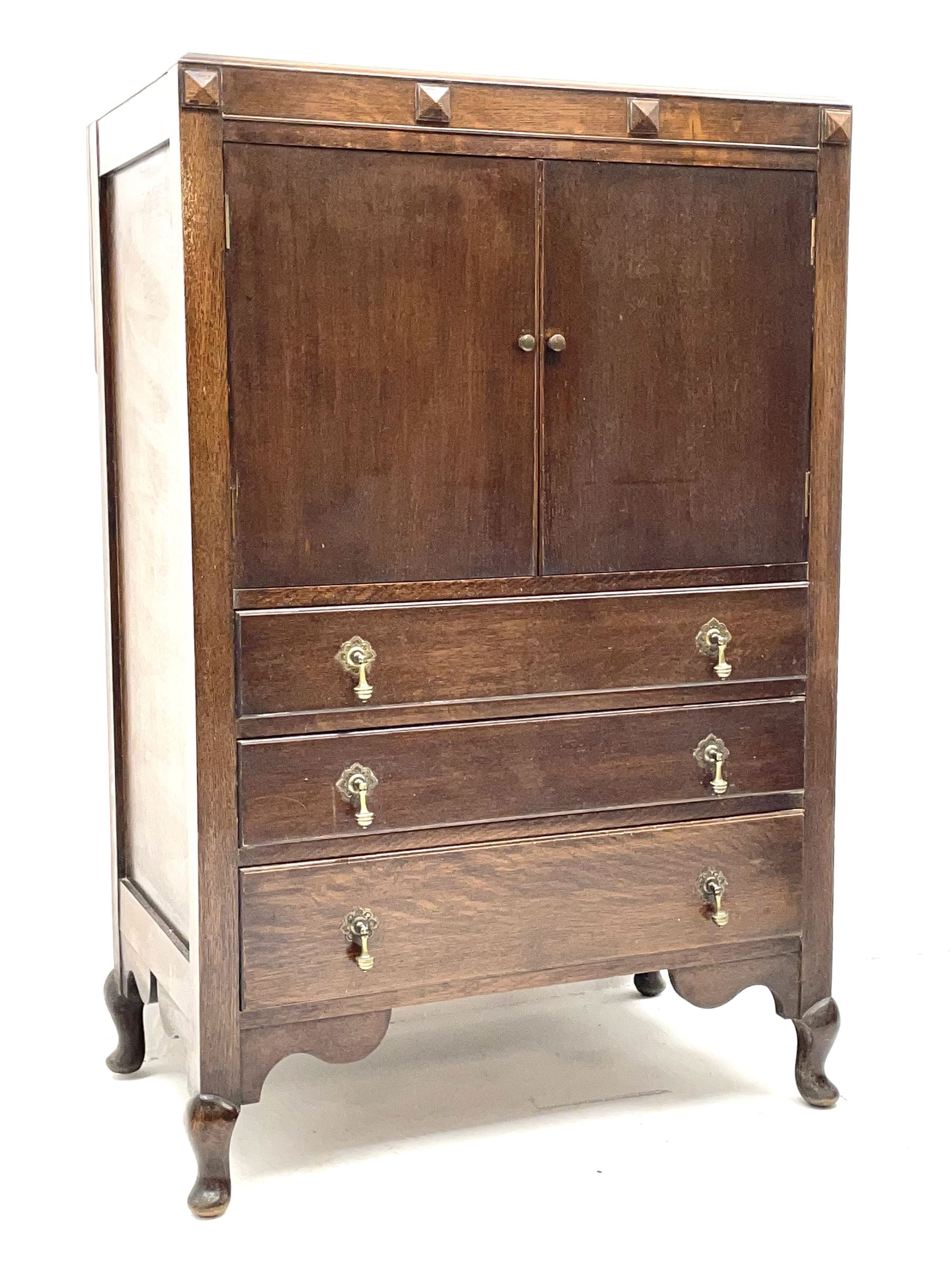Early 20th century oak tallboy chest, double cupboard doors enclosing interior, above three long graduating drawers, raised on cabriole supports 