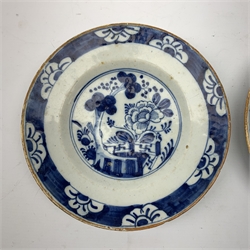 A pair of late 18th century/early 19th century blue and white Delft plates, of circular form decorated with blossoming trees and flowers, within foliate borders, D23cm. 
