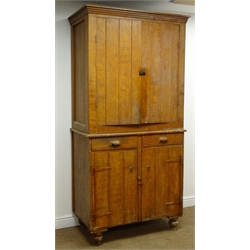  Early 20th century stained and grained pine kitchen cabinet, projecting cornice, two doors above two drawers and two cupboard doors enclosing shelves, turned supports, W102cm, H207cm, D57cm  