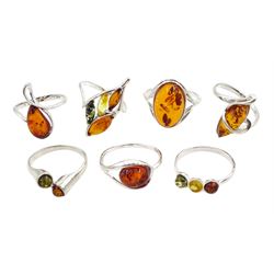 Seven silver amber stone set rings, all stamped or tested
