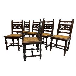 Set six early 20th century oak chairs, the uprights carved with foliage motifs, fretwork back with flower head roundel, cane work seat, on turned supports joined by turned stretchers 