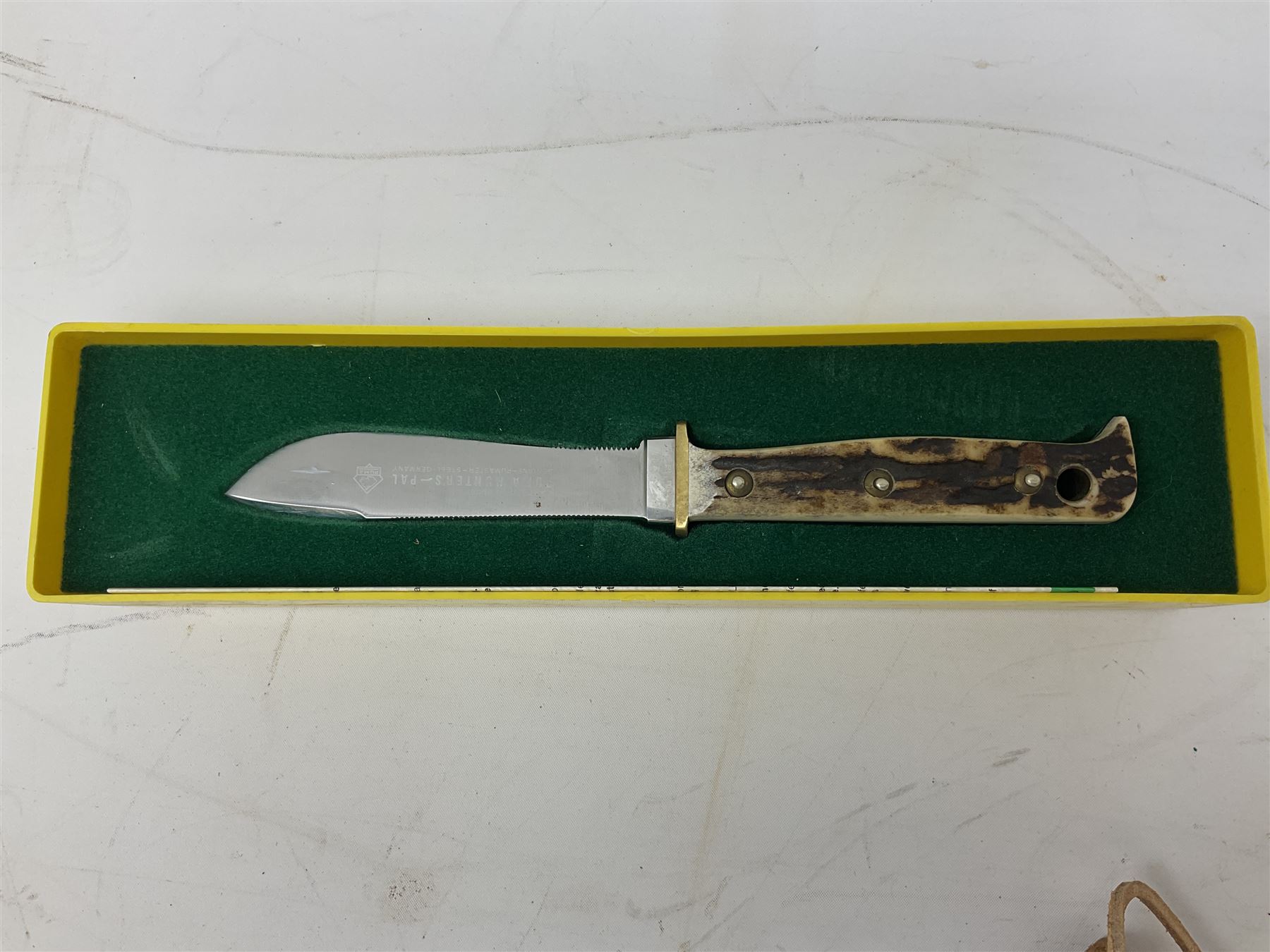 German Puma Hunter's-Pal knife, the 10cm steel blade marked model 6397, serial No.72573 to guard, fixed blade, antler scales; in original hard plastic case with paperwork and guarantee label; with brown leather sheath marked Puma L22.5cm overall