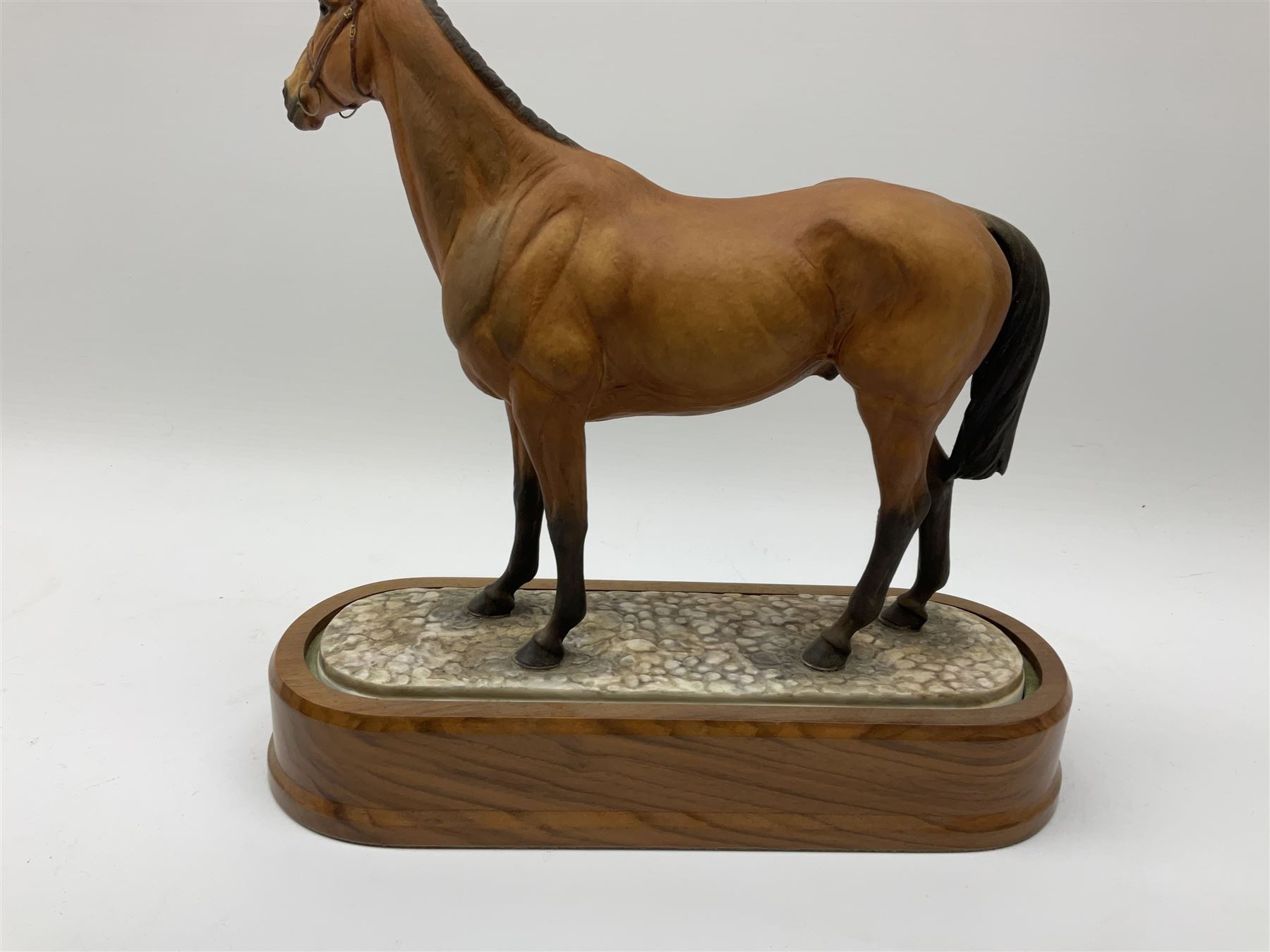 A Royal Worcester limited edition figure, Arkle, owned by the Duchess of Westminster, modelled by Doris Lindner, on wooden base, H27cm. 