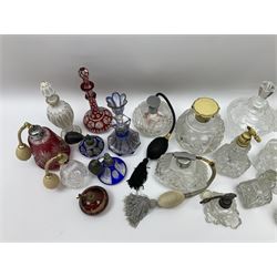 Bohemian flashed and overlayed perfume bottles and atomisers, to include a blue bohemian example of octagonal form with gilt detailing and petal cut stopper, cranberry examples, and a number of clear cut and moulded glass with faceted edges