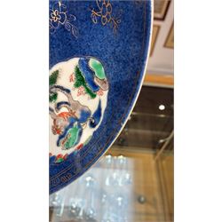 Chinese powder blue ground famille verte charger, possibly Kangxi, decorated with a central cartouche enclosing two female figures, with smaller shaped panels enclosing lions and foliage, square seal mark in blue to base, D28cm