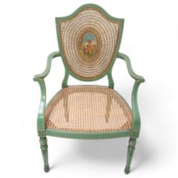 Pair of Edwardian Hepplewhite Revival green-painted open armchairs, cane work shield back with central oval panel panted with putto set upon rocky landscape with water and trees, shaped and rolled arms enclosing cane work seat, on turned front supports decorated with acanthus leaves and draped festoons 