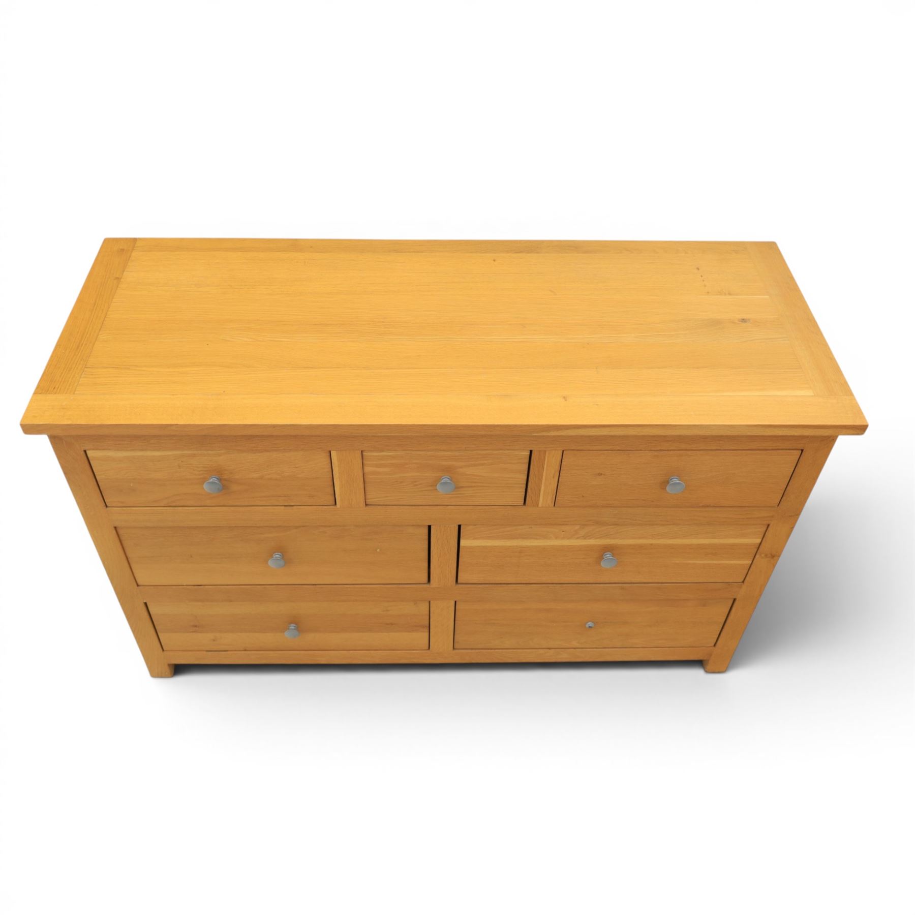 Solid oak chest of drawers, three over four drawers with metal pulls 