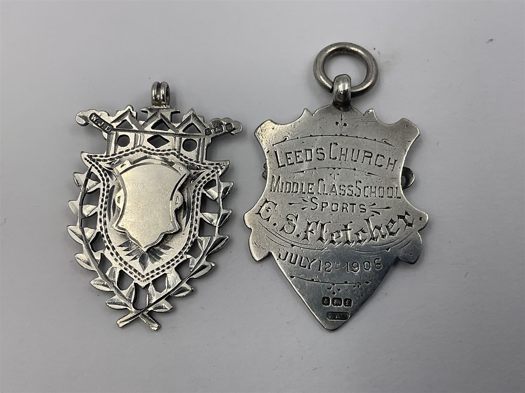 Seven Edwardian and later silver cartouche fobs, to include five gold faced examples and three double sided examples, all hallmarked with various dates and makers
