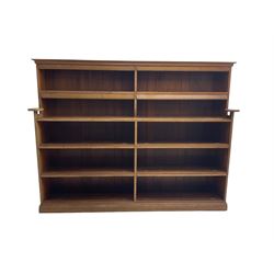 20th century oak double bookcase, ten shelves fitted with hinged spine covers, on moulded plinth base