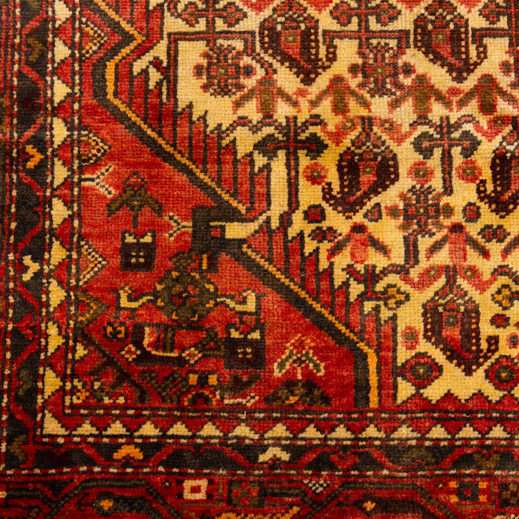North West Persian Malayer hand-knotted rug, ivory field with central stepped lozenge medallion with angular pendants, surrounded by rows of stylized boteh and geometric floral devices within multiple geometric and stylized vine borders, with fringe ends