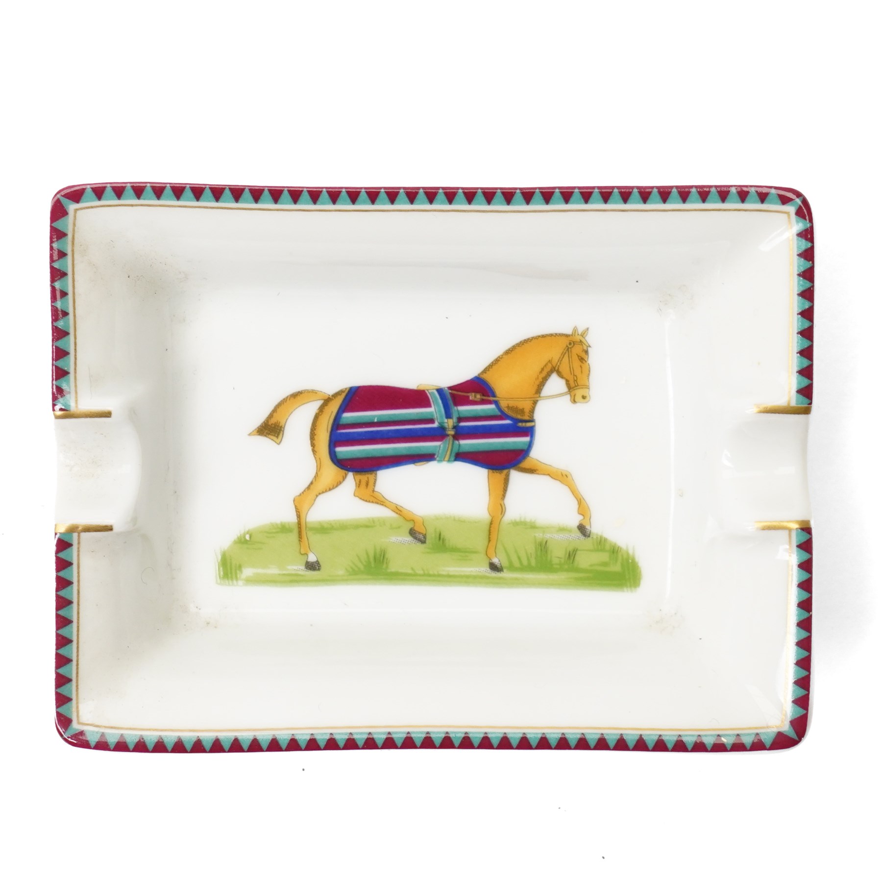 Hermès - set of four miniature porcelain ashtrays, each decorated with a horse in differing blanket, with gilt and coloured borders, in contrasting colour with various horse-coats, in original fitted box