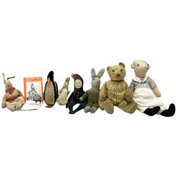 1950's teddy bear with jointed limbs, revolving head, wood filled body, stitched nose and mouth, applied glass eyes and foot pads, together with a quantity of handmade soft toy rabbits and penguins. 