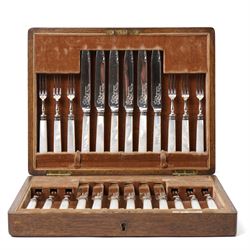 Set of twelve dessert knives and forks with engraved plated blades, silver collars and mother of pearl handles by Walker & Hall in oak box Sheffield 1927 and a set of twelve plated fish knives and forks with servers, boxed