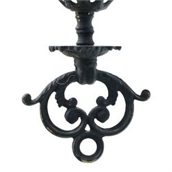 Late 19th century wrought metal hanging ceiling lamp, the ornate pierced central reservoir-form body with mounted eagle, three scrolling branches fitted with three clear glass chimney shades, suspended by decorative chains from a pierced ceiling rose
