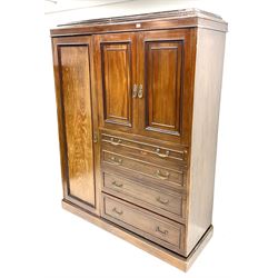 Edwardian mahogany combination wardrobe, with dentil cornice over full length cupboard wth interior fitted for hanging, flanking two panelled cupboards enclosing more provision for hanging, over four graduated drawers, the top one stamped 'Thos Turner, Manchester'