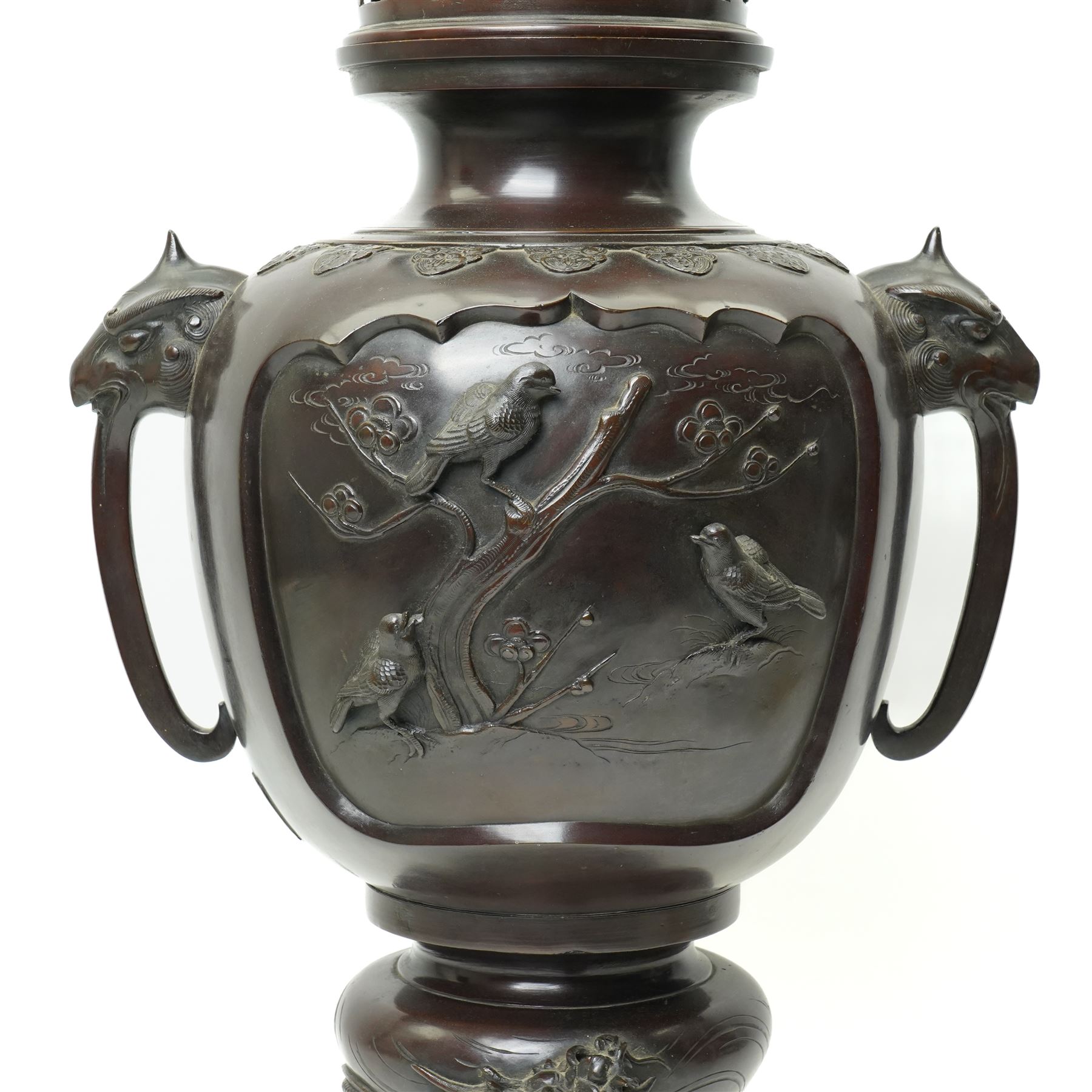 Japanese late Meiji period bronze koro and cover, surmounted by an eagle finial and with bird decoration in high relief to each side, twin elephant trunk handles, bearing indistinct character signature to one side, H82cm