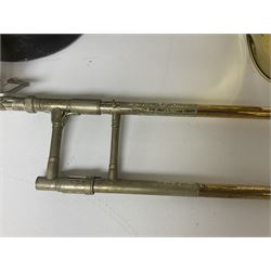 Three brass trombones comprising Elkhart Ind. USA 'CONN' model no.72H; Besson 'Concord'; and Selmer Distributed 'Lincoln'; two in carrying cases; and German B & M 'Champion' brass trumpet (4)