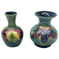 Moorcroft vase, decorated in the Leaf and Berries pattern upon a tonal green ground, together with a further Moorcroft vase, of squat baluster form, decorated in the Iris pattern upon a tonal green ground, each with impressed marks beneath, each H9cm. 