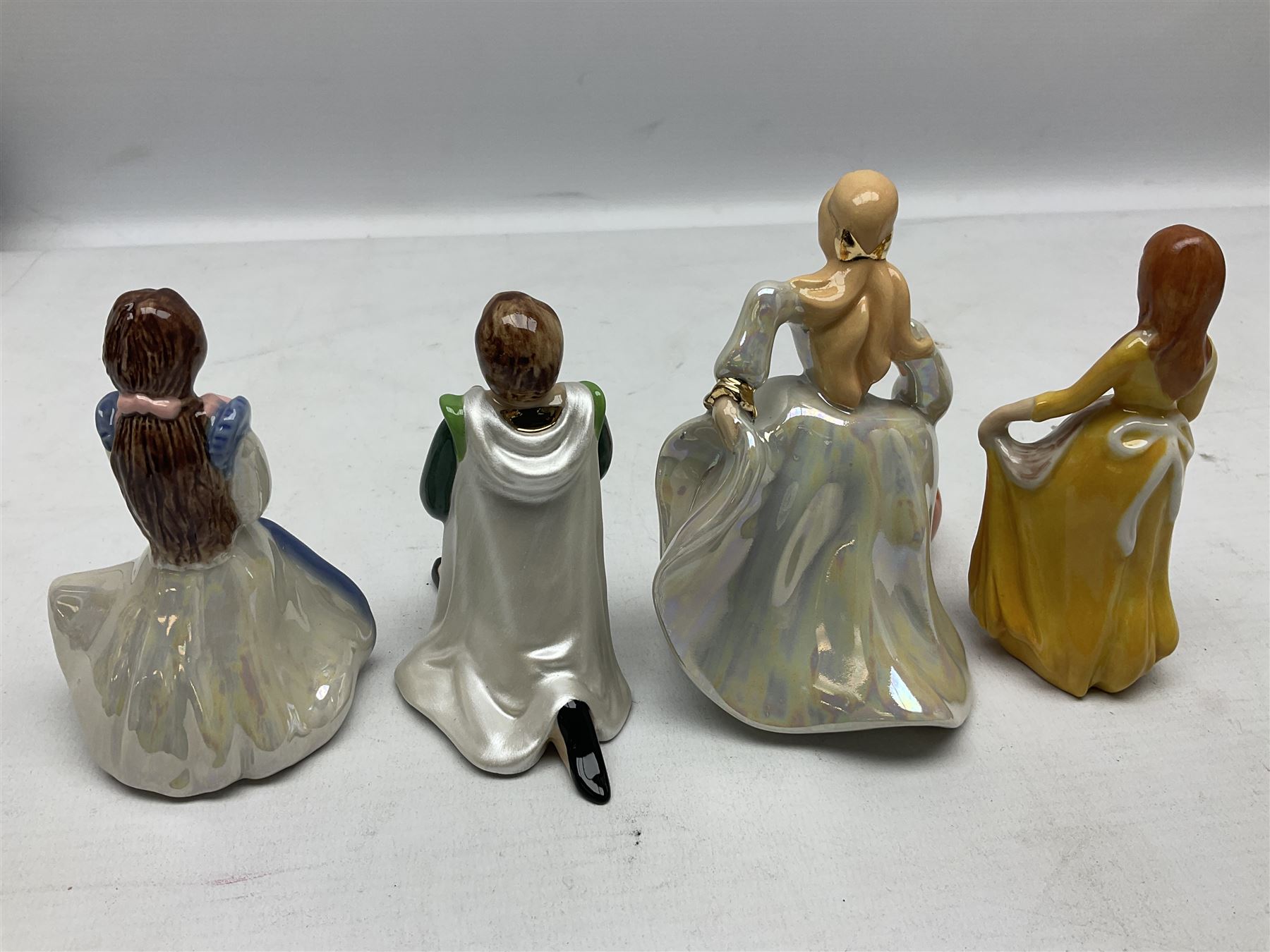 Thirteen Wade Collectors Club figures, comprising six Alice in Wonderland figures; Queen of Hearts, Alice, Mad Hatter, The Doormouse, White Rabbit and Cheshire cat, six Cinderella figures; Fairy Godmother, Cinderella Ready for the Ball, Prince Charming, Cinderella, Clorinda and Thisbe, together with Beauty from Beauty and the Beast, all with original boxes  