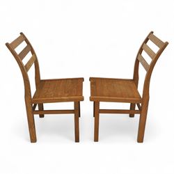 Treske of Thirsk - solid oak refectory dining suite, rectangular top with chamfered edge over trestle base united by a central stretcher, together with six matching slat back dining chairs, including two carvers, with panelled seats and square legs united by stretchers (H 87cm, W 62cm, D 57cm)