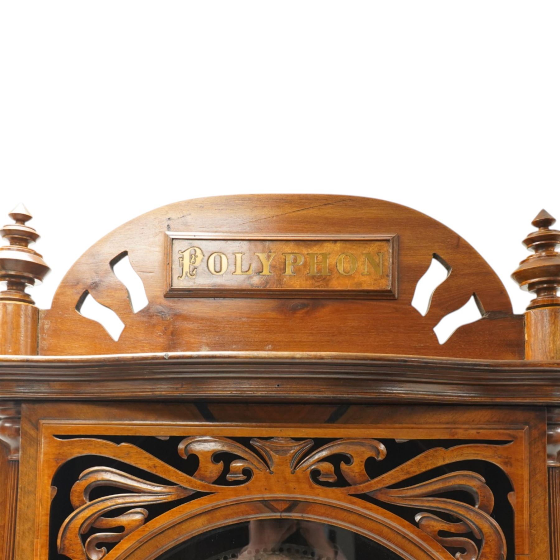 Late 19th century coin operated floor standing Polyphon, the shaped cornice marked 'Polyphon' with eleven 50cm discs in a walnut case with glazed upper section, the coin slot marked '1 Penny', the lower section with fall front for disc storage and inset with a portrait print and on compressed bun feet H230cm x W76cm x D46cm with a number of old pennies